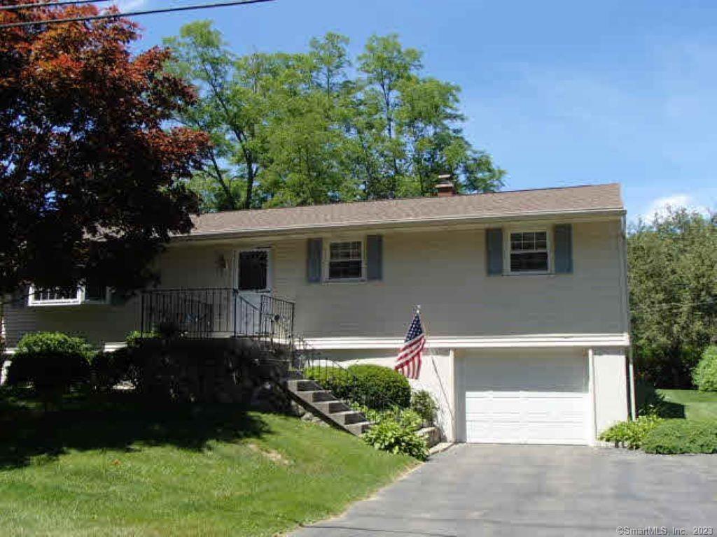35 Buckland Street Wolcott, CT 06716 - Photo 1 of 1 a front view of a house with a garden