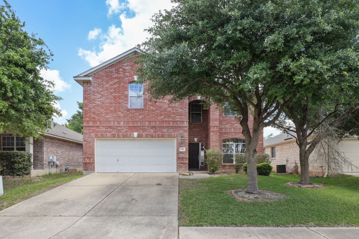 628 Rusk Road Round Rock, TX 78665 - Photo 1 of 1 a front view of a house with a yard and garage