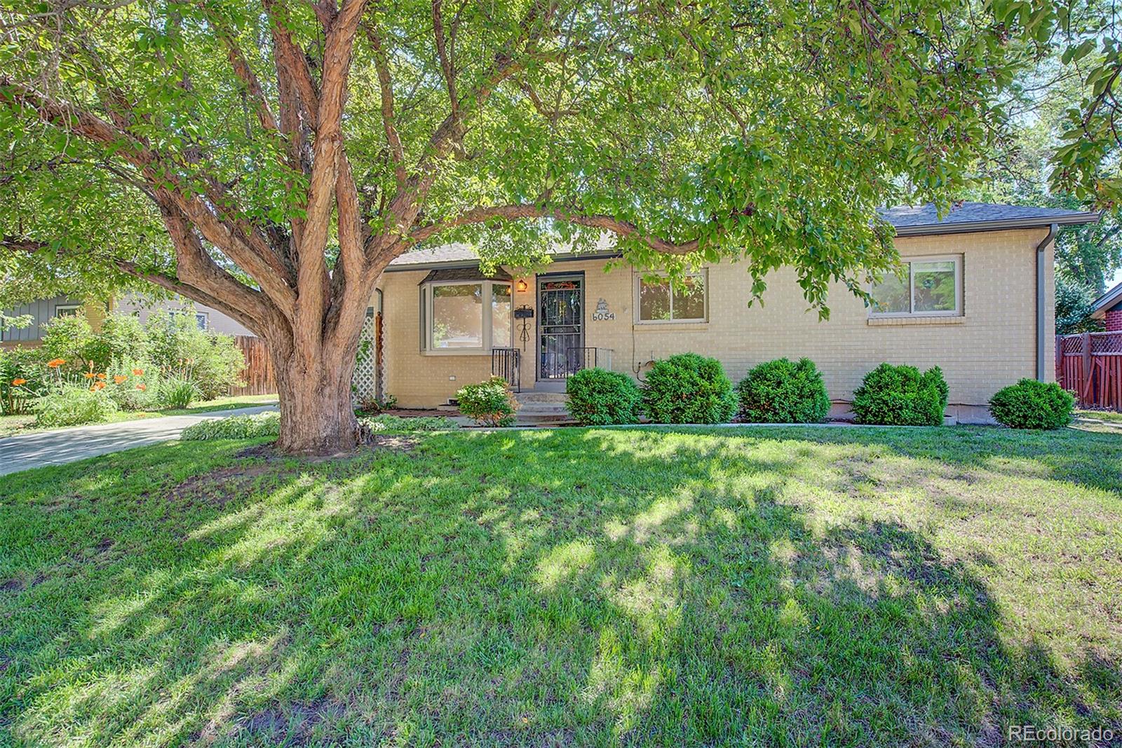6054 Iris Way Arvada, CO 80004 - Photo 2 of 44 a front view of a house with garden