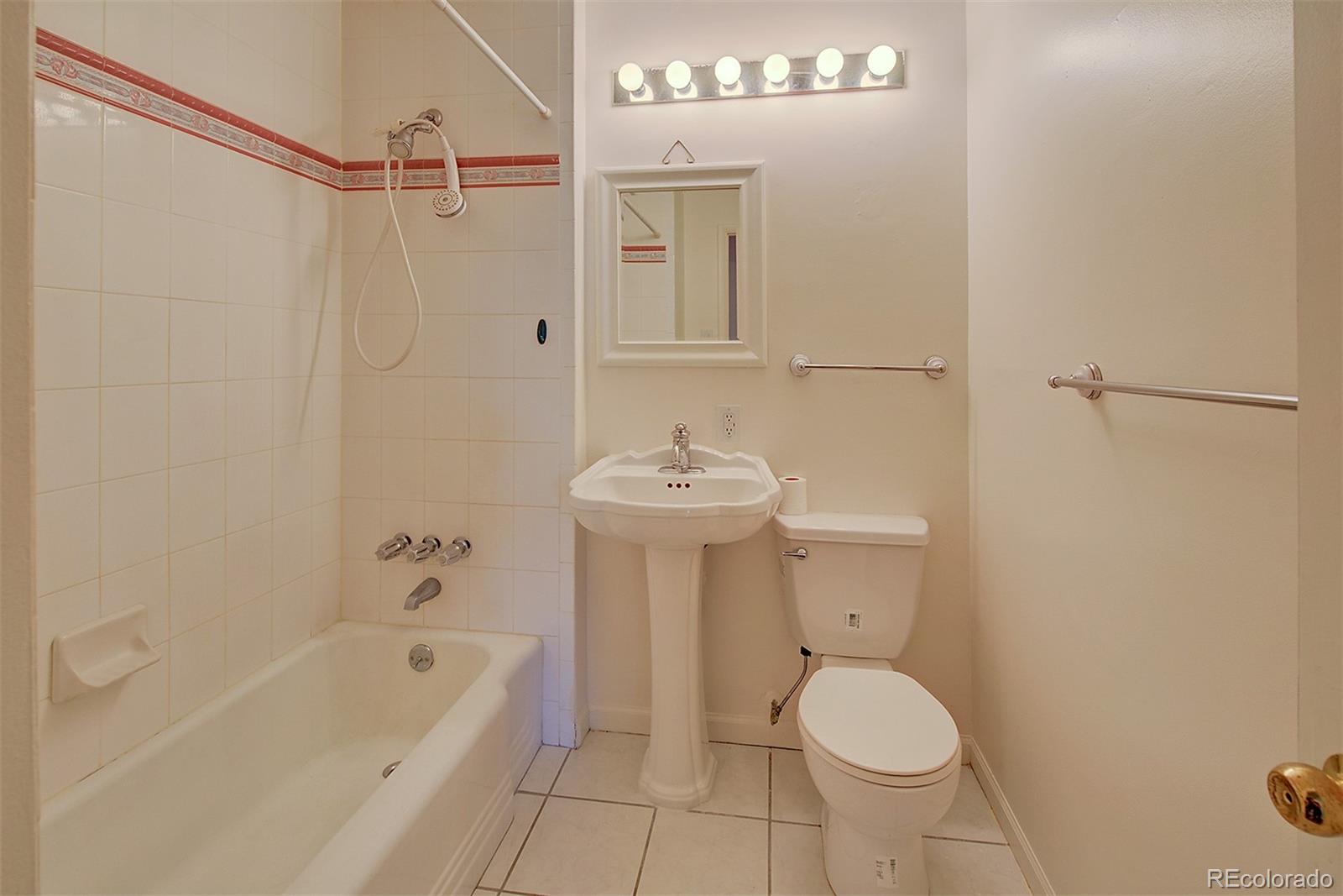 6054 Iris Way Arvada, CO 80004 - Photo 22 of 44 a bathroom with a sink a toilet and shower