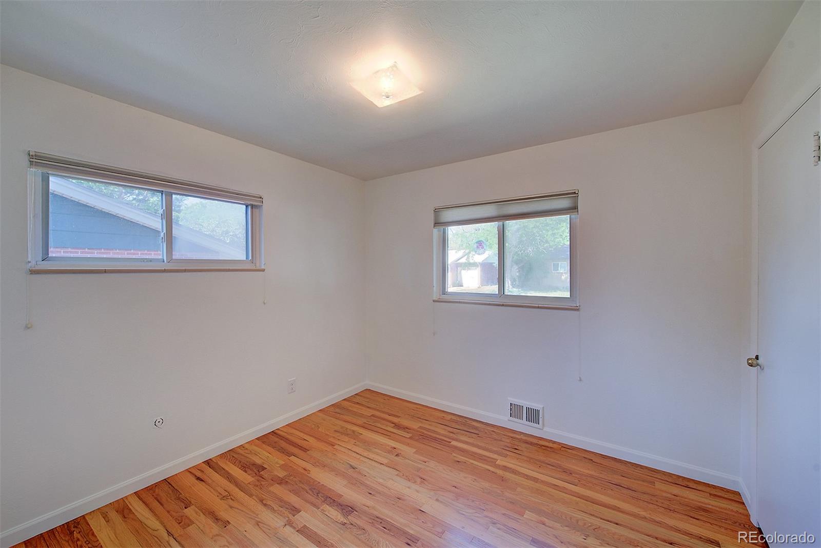 6054 Iris Way Arvada, CO 80004 - Photo 23 of 44 a view of a room with wooden floor and windows