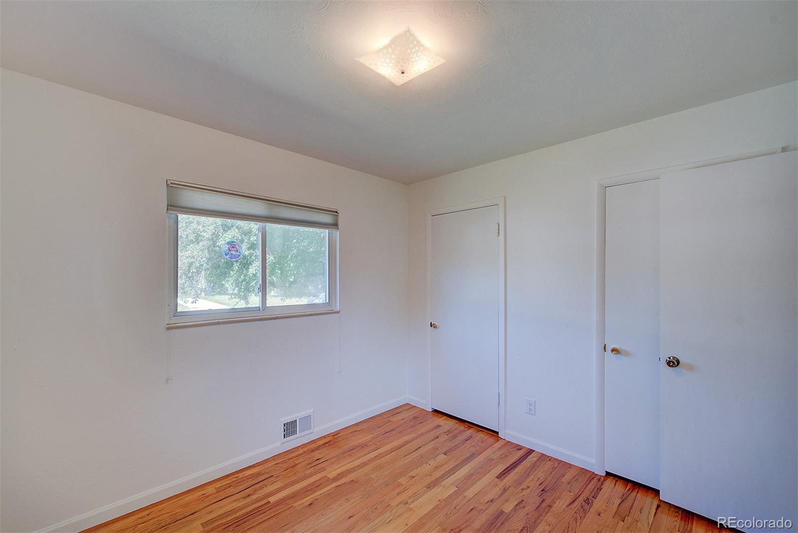 6054 Iris Way Arvada, CO 80004 - Photo 24 of 44 a view of empty room with wooden floor