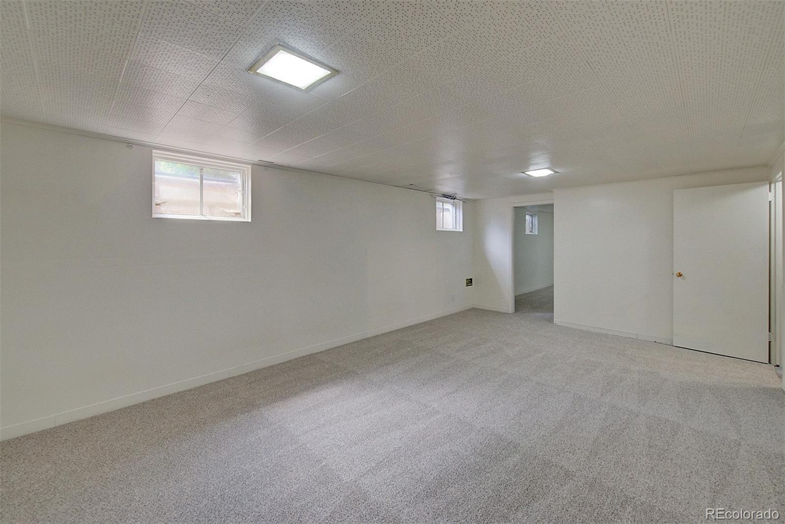 6054 Iris Way Arvada, CO 80004 - Photo 28 of 44 a view of an empty room with a window