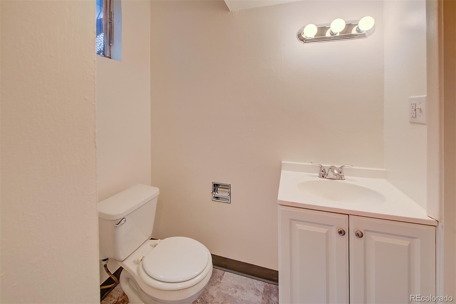 6054 Iris Way Arvada, CO 80004 - Photo 31 of 44 a white toilet sitting next to a white sink