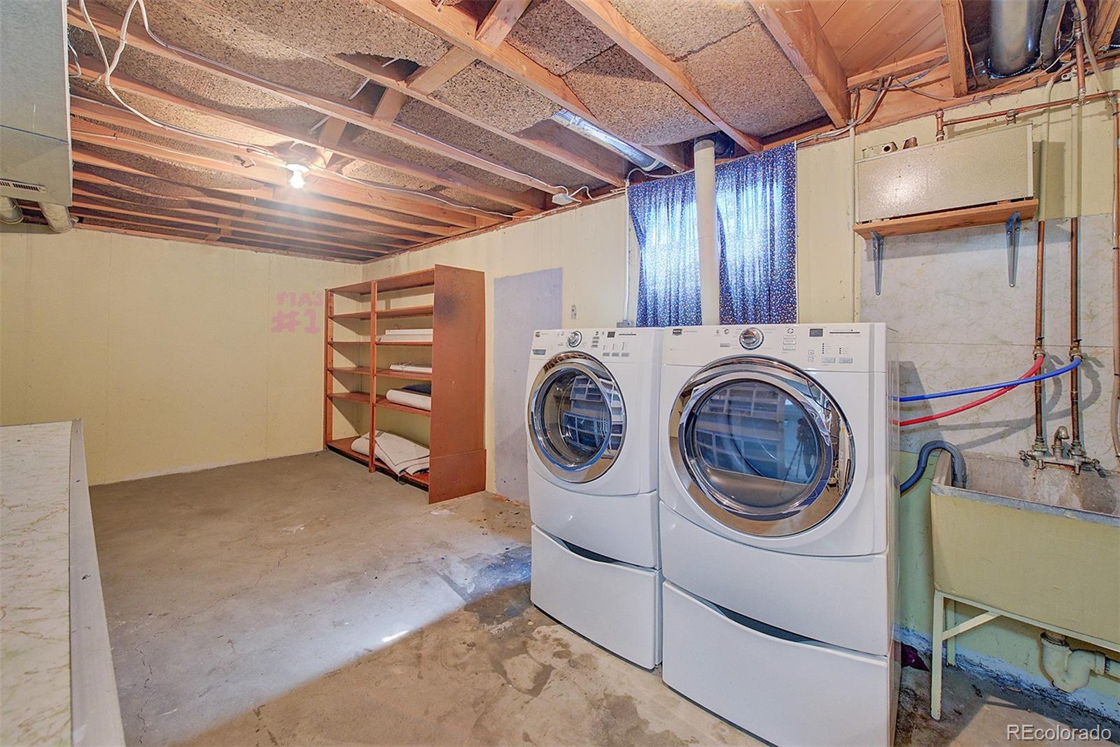 6054 Iris Way Arvada, CO 80004 - Photo 35 of 44 a utility room with dryer and washer