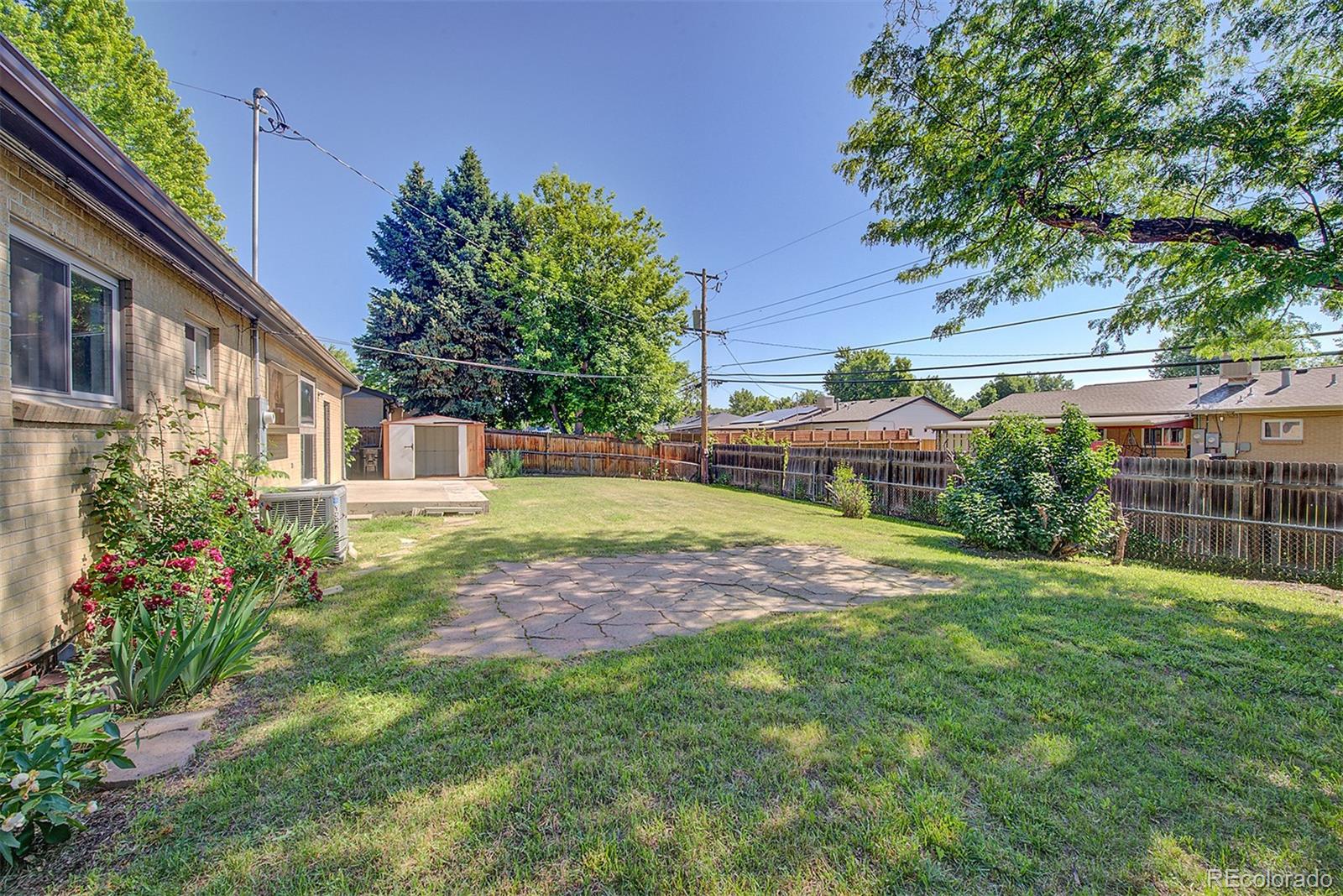6054 Iris Way Arvada, CO 80004 - Photo 40 of 44 a backyard of a house with lots of green space