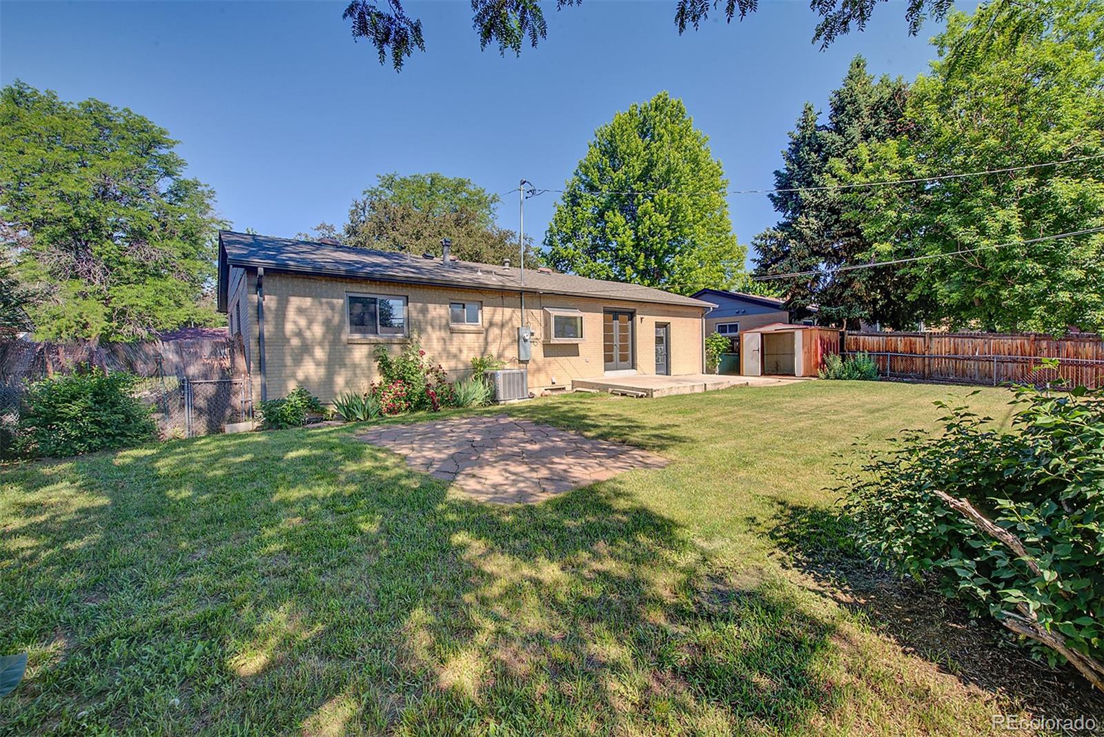 6054 Iris Way Arvada, CO 80004 - Photo 41 of 44 front view of a house with a yard