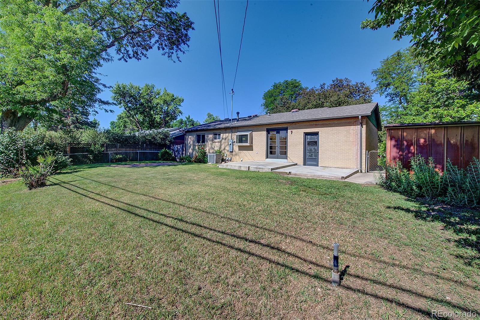6054 Iris Way Arvada, CO 80004 - Photo 42 of 44 a view of a house with a yard
