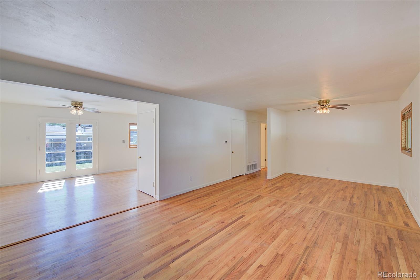 6054 Iris Way Arvada, CO 80004 - Photo 6 of 44 wooden floor in an empty room with a window