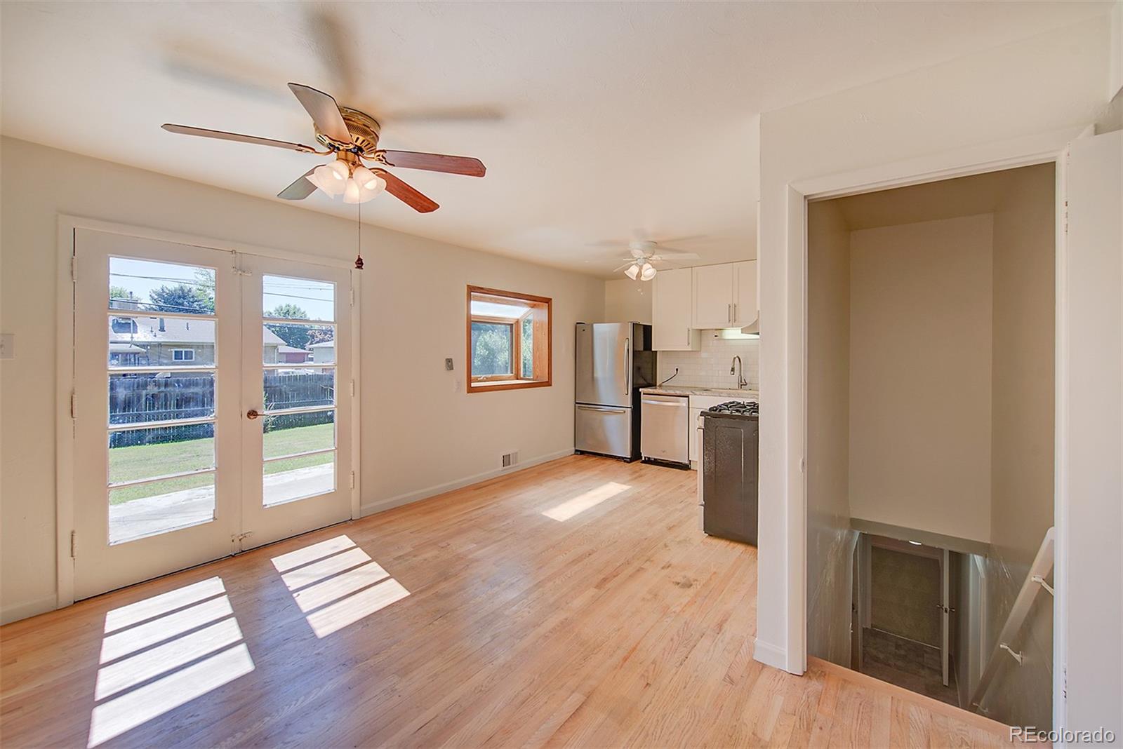 6054 Iris Way Arvada, CO 80004 - Photo 8 of 44 a view of empty room with wooden floor and fan