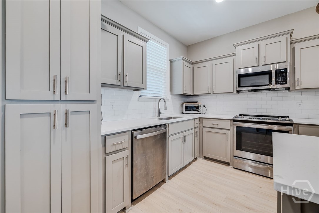 120 Sweetwater Circle Rincon, GA 31326 - Photo 12 of 48 All stainless appliances and a large double pantry, (just around corner in the laundry, there is a good sized walk-in closet that can be used as a back-up pantry)
