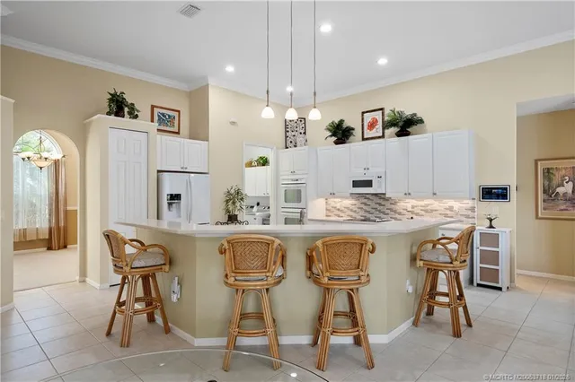 a bedroom with a bed a study table and large window