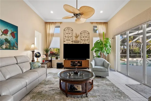 a view of a white house with a big yard and potted plants