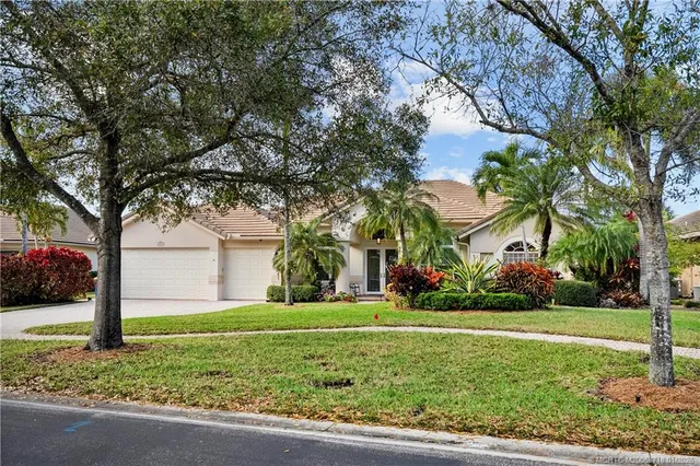 a view of a dining room with furniture a chandelier and wooden floor