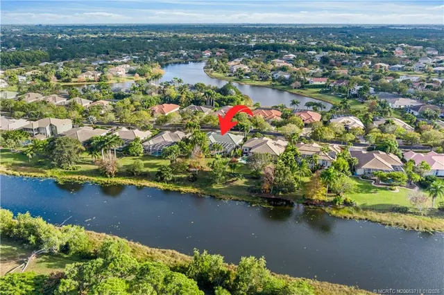 a living room with furniture a flat screen tv and a large window