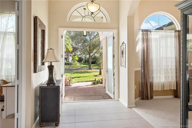 a living room with furniture a flat screen tv and a large window