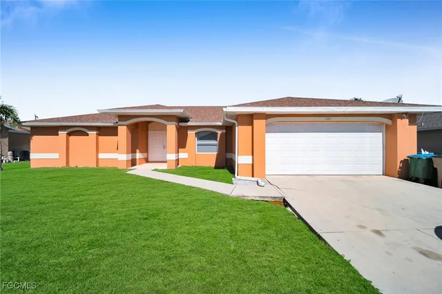 a front view of a house with a yard and garage