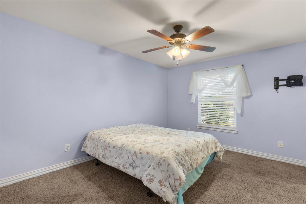 4504 Jennings Avenue Wichita Falls, TX 76310 - Photo 17 of 26 a bedroom with a bed and a chandelier