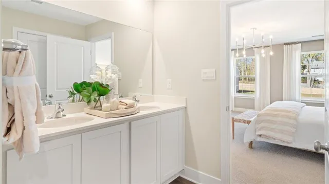 a en suite bathroom with a double sink and mirror