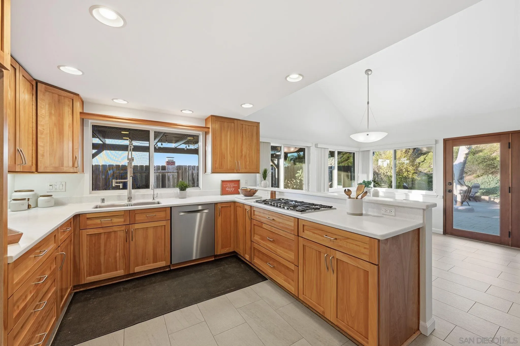17570 Montero Road San Diego, CA 92128 - Photo 12 of 40 a large kitchen with a sink and dishwasher with a large kitchen island