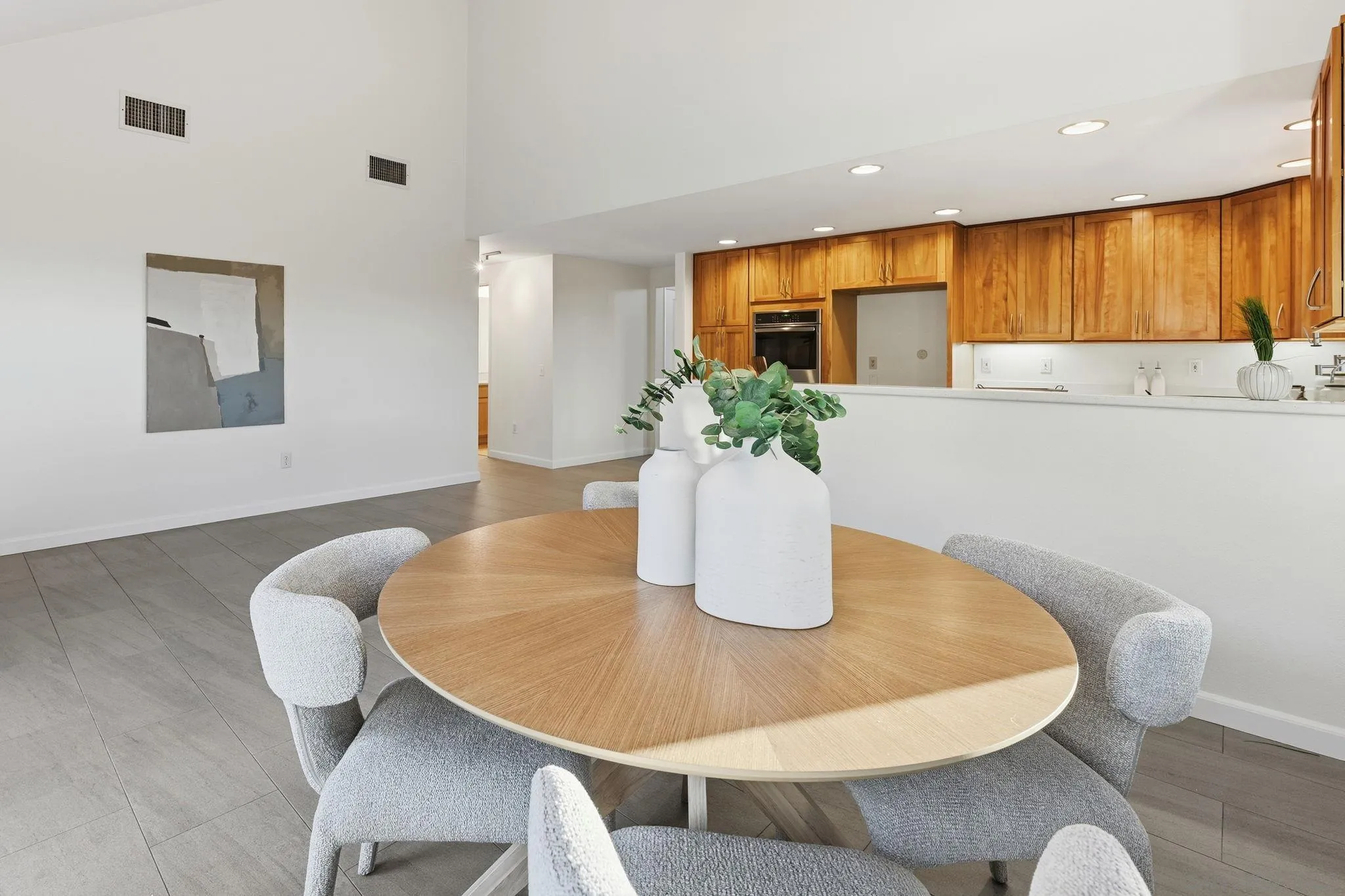 17570 Montero Road San Diego, CA 92128 - Photo 14 of 40 a dining room with furniture and wooden floor