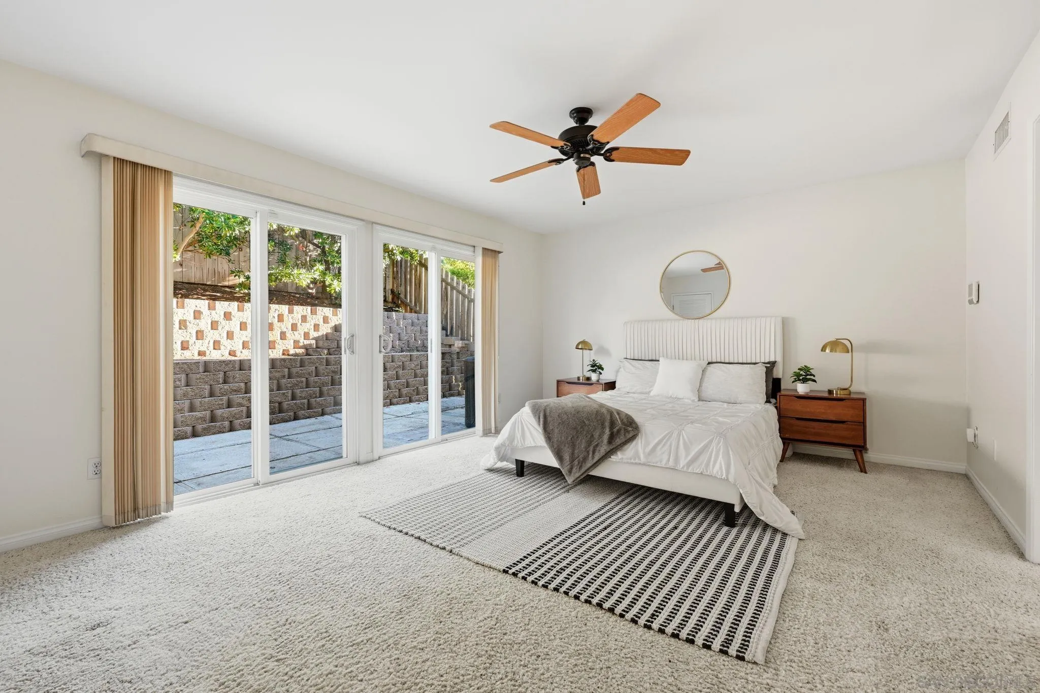 17570 Montero Road San Diego, CA 92128 - Photo 16 of 40 a bedroom with a bed and glass door