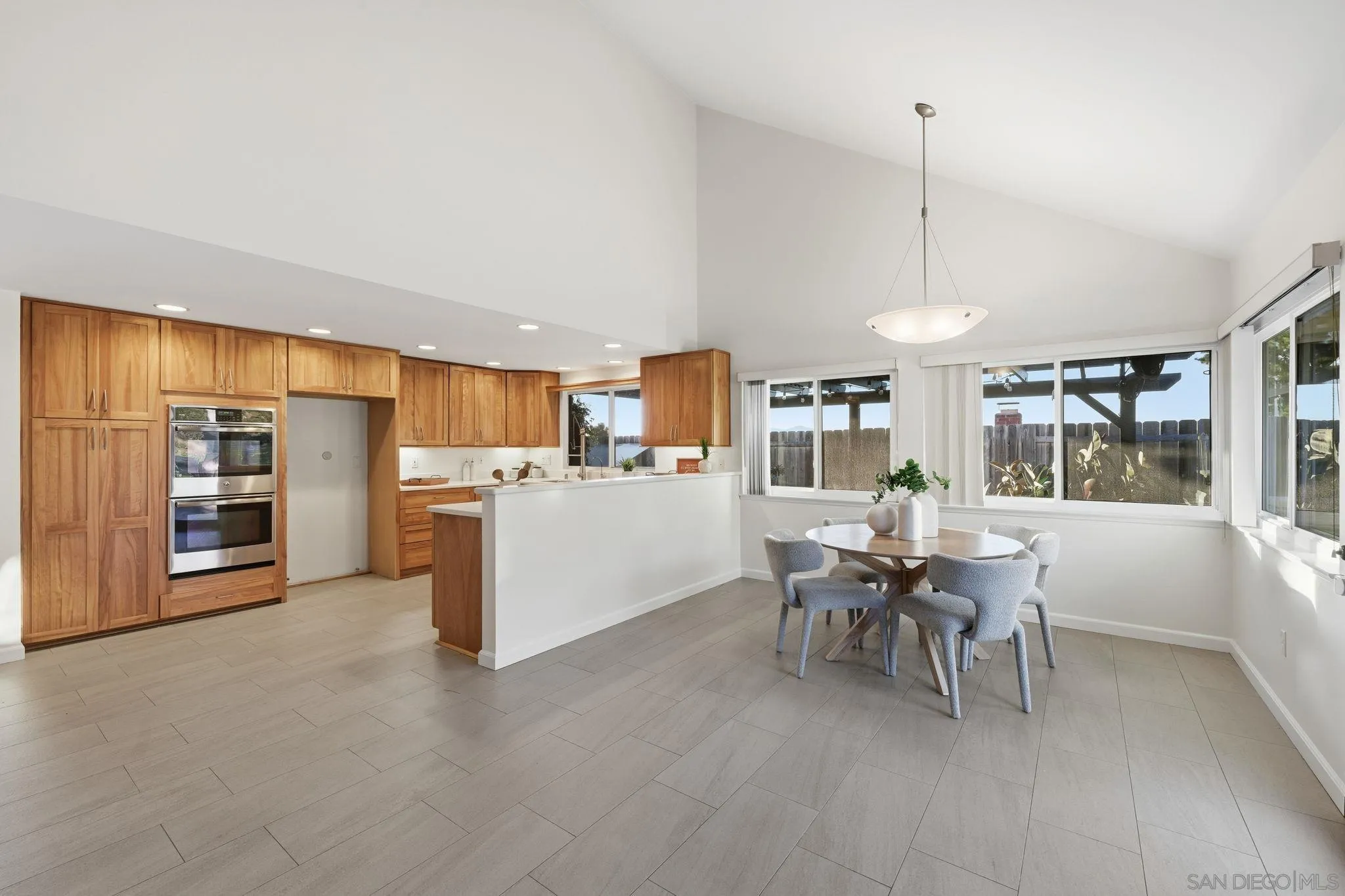 17570 Montero Road San Diego, CA 92128 - Photo 9 of 40 a view of a kitchen with furniture and chandelier