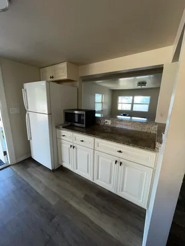 a kitchen with a refrigerator a sink and cabinets