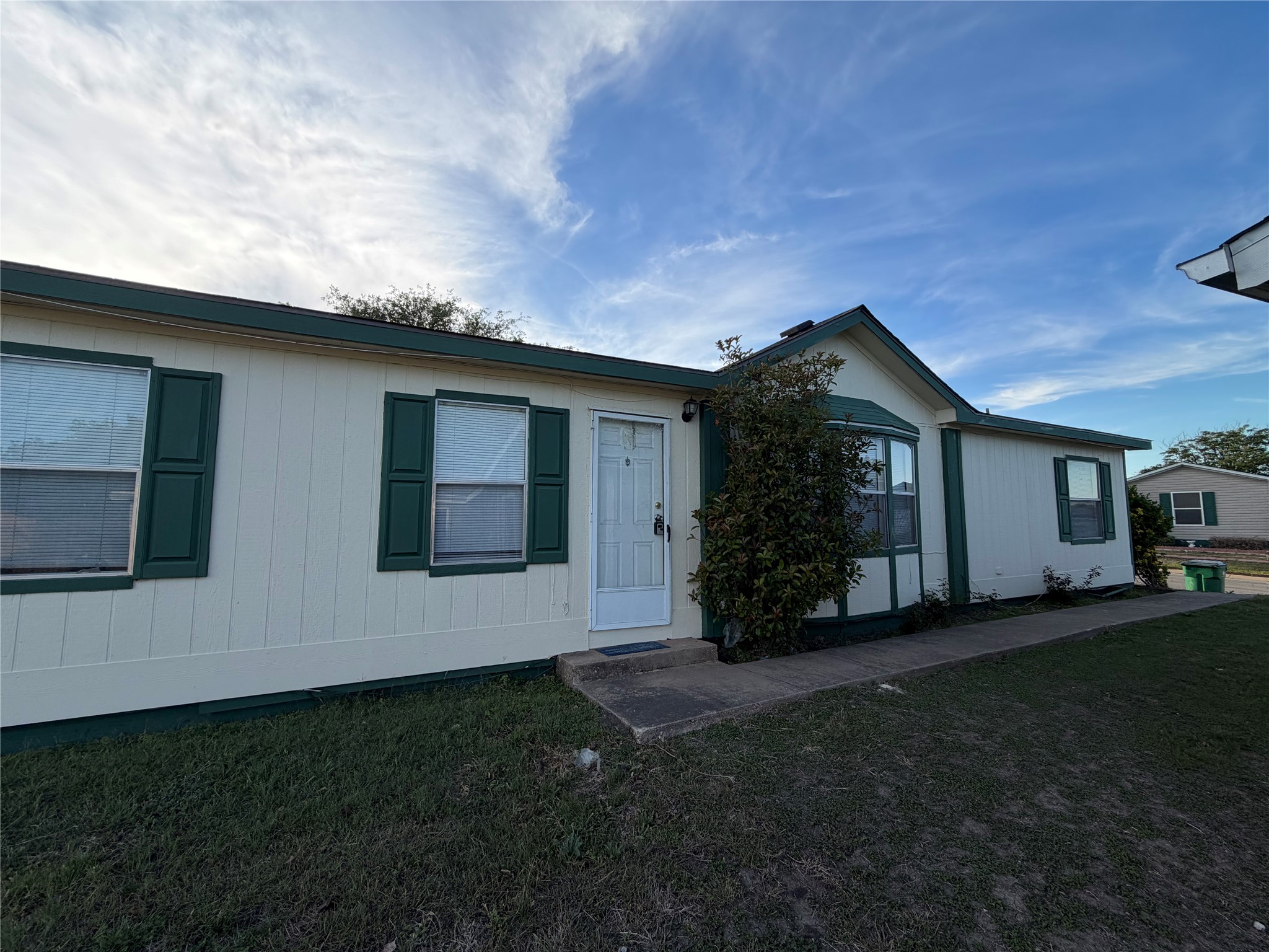 12609 Dessau Road, Unit 410 Austin, TX 78754 - Photo 2 of 11 Cream-colored siding exterior with dark green trim and shutters