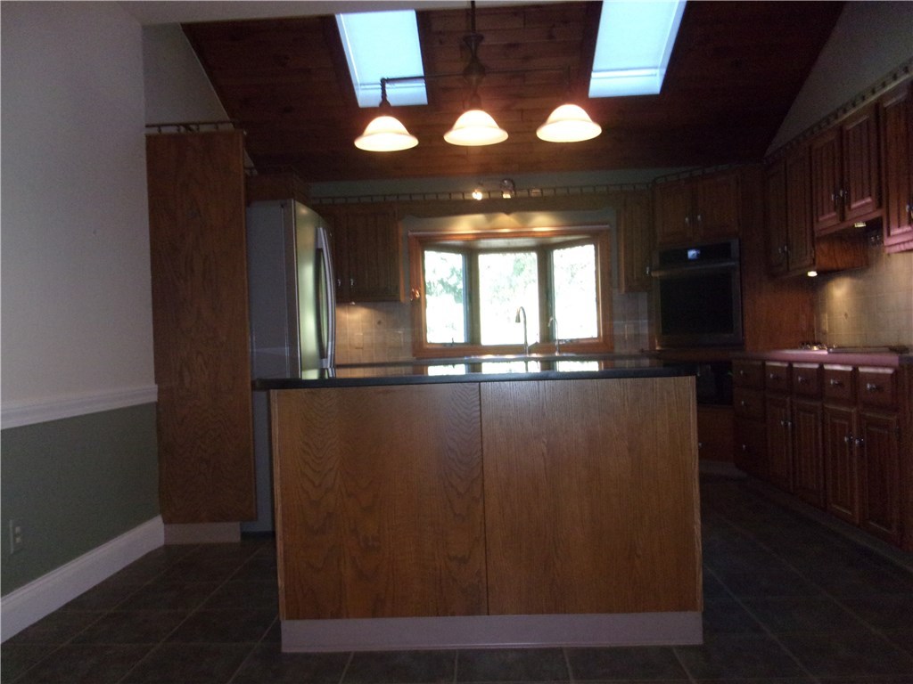 115 Abbott Run Valley Road Cumberland, RI 02864 - Photo 16 of 30 Kitchen with island, skylights, newer appliances/View from dining room.
