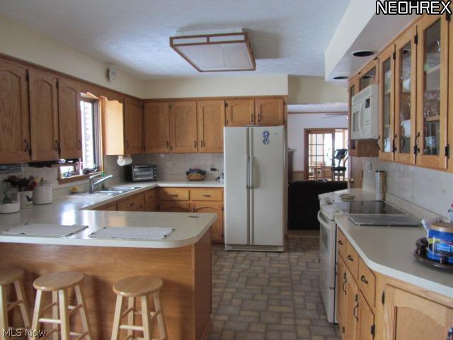 5204 Rootstown Road Ravenna, OH 44266 - Photo 6 of 20 The kitchen has loads of cabinets, a breckfast bar - a nice size eating area and even a fireplace! Appliances stay.
