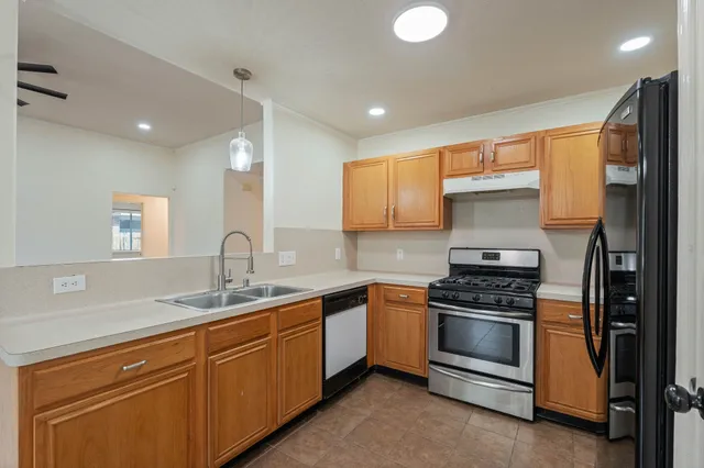 a view of a big room with windows and chandelier