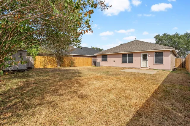 a view of wooden floor chandelier and windows in a room