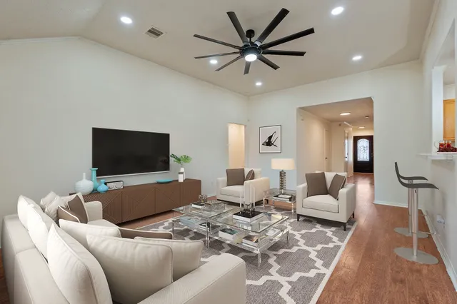 a view of a hallway with wooden floor and staircase