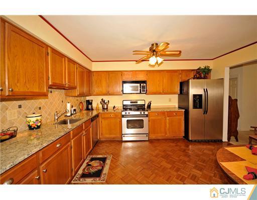 135 Redpine Loop Old Bridge, NJ 08857 - Photo 2 of 9 a kitchen with stainless steel appliances a stove a sink and a refrigerator