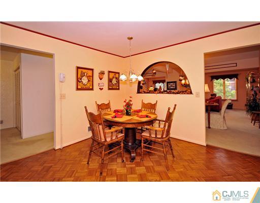 135 Redpine Loop Old Bridge, NJ 08857 - Photo 3 of 9 a view of a dining room with furniture and chandelier