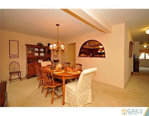 135 Redpine Loop Old Bridge, NJ 08857 - Photo 6 of 9 a view of a dining room with furniture and chandelier
