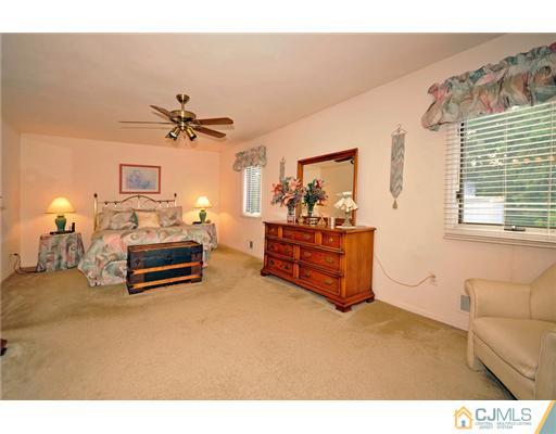 135 Redpine Loop Old Bridge, NJ 08857 - Photo 7 of 9 a living room with furniture and a chandelier