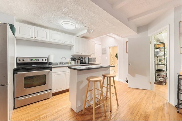 20 East Goethe Street, Unit 104 Chicago, IL 60610 - Photo 11 of 18 a kitchen with stainless steel appliances a stove a sink and a refrigerator