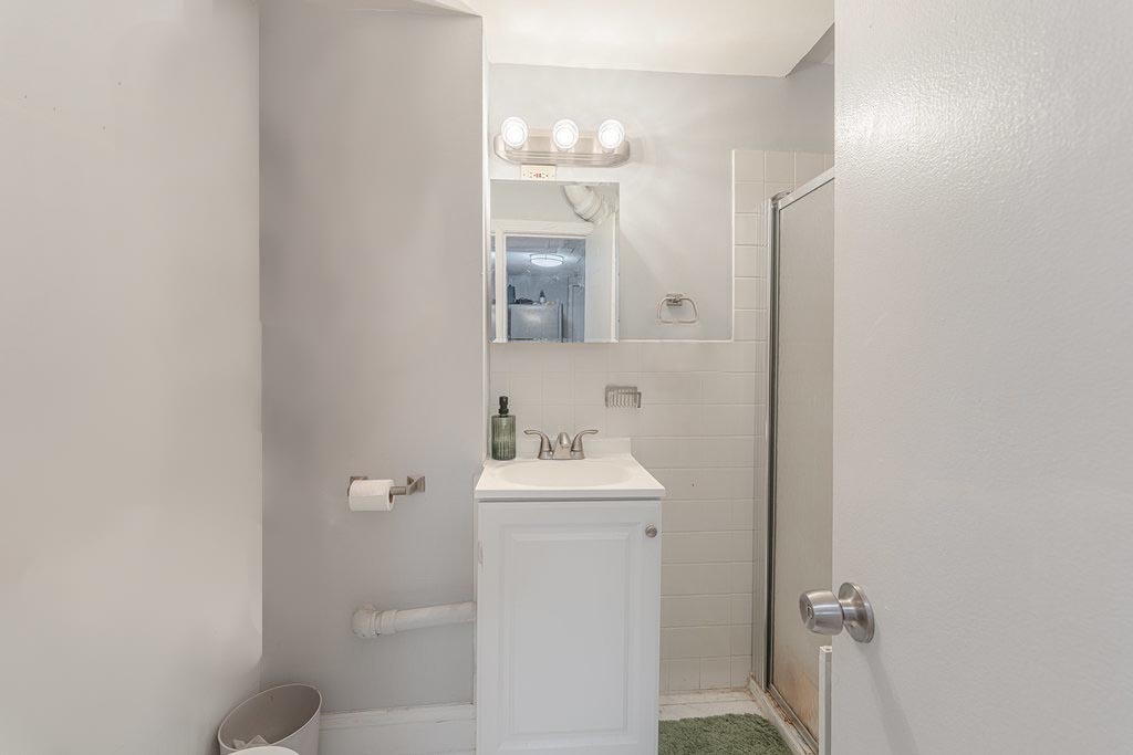 20 East Goethe Street, Unit 104 Chicago, IL 60610 - Photo 13 of 18 a bathroom with a sink mirror and toilet