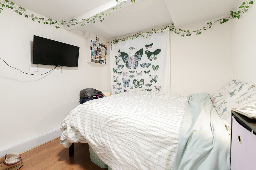 20 East Goethe Street, Unit 104 Chicago, IL 60610 - Photo 14 of 18 a bedroom with a bed tv and a window