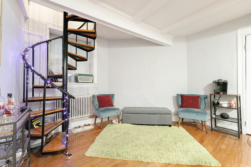 20 East Goethe Street, Unit 104 Chicago, IL 60610 - Photo 15 of 18 a living room with furniture and a rug