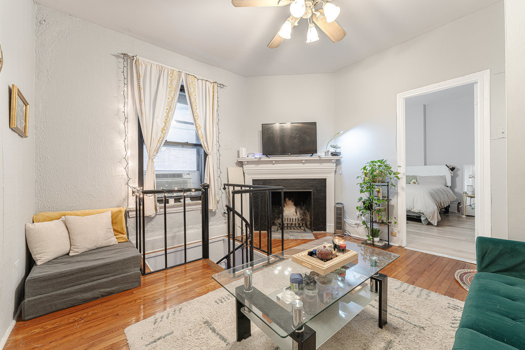 20 East Goethe Street, Unit 104 Chicago, IL 60610 - Photo 3 of 18 a living room with furniture a fireplace and a flat screen tv