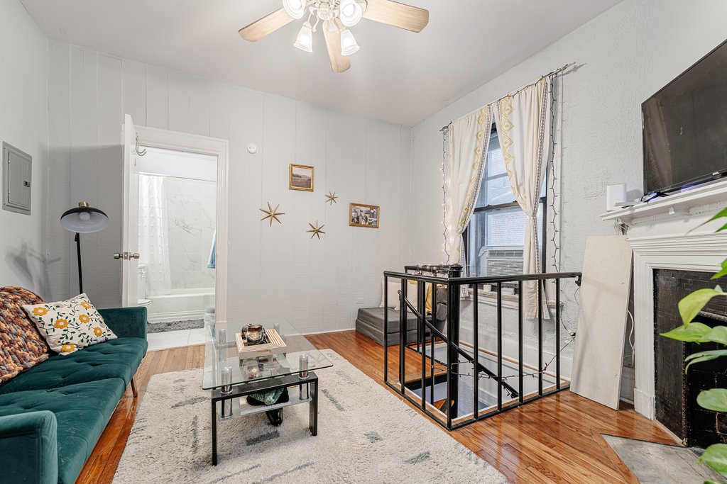 20 East Goethe Street, Unit 104 Chicago, IL 60610 - Photo 4 of 18 a bedroom with furniture and a flat screen tv