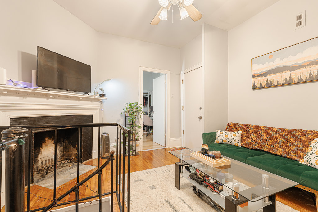20 East Goethe Street, Unit 104 Chicago, IL 60610 - Photo 5 of 18 a living room with furniture and a flat screen tv