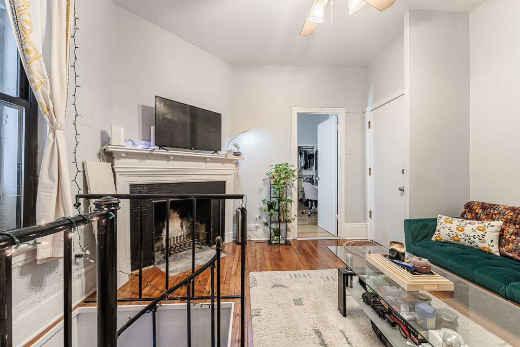 20 East Goethe Street, Unit 104 Chicago, IL 60610 - Photo 6 of 18 a living room with furniture and a fireplace