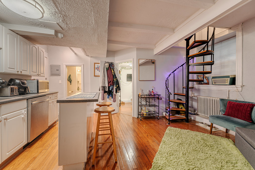 20 East Goethe Street, Unit 104 Chicago, IL 60610 - Photo 10 of 18 a very nice looking room with many windows and furniture