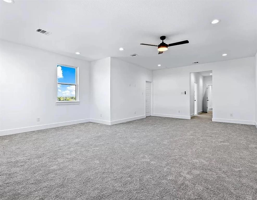 1605 Logan Street Fort Worth, TX 76104 - Photo 11 of 17 an empty room with a ceiling fan and a window