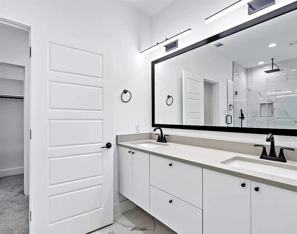 1605 Logan Street Fort Worth, TX 76104 - Photo 12 of 17 a bathroom with a double vanity sink and mirror