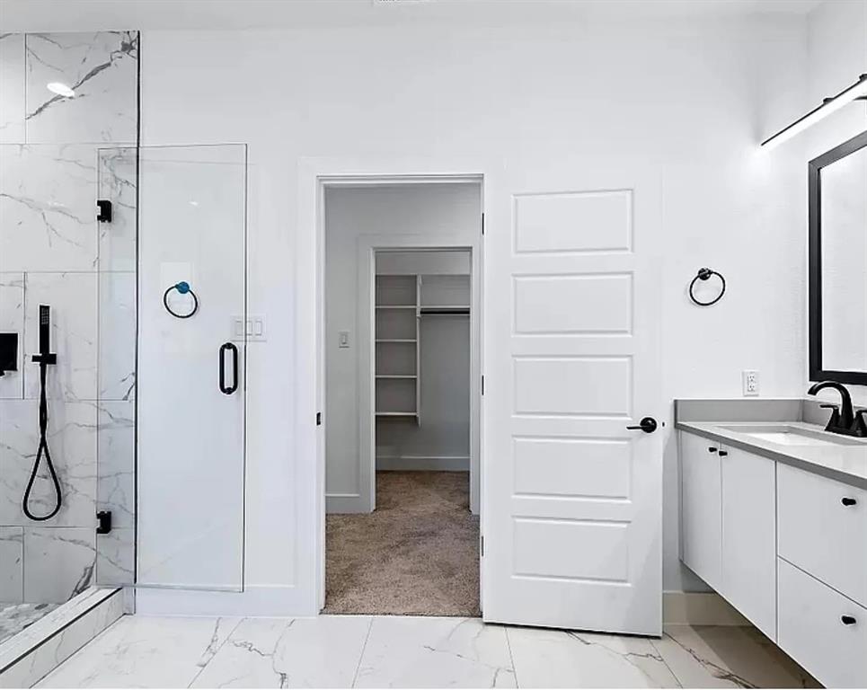 1605 Logan Street Fort Worth, TX 76104 - Photo 13 of 17 a bathroom with a shower sink and mirror